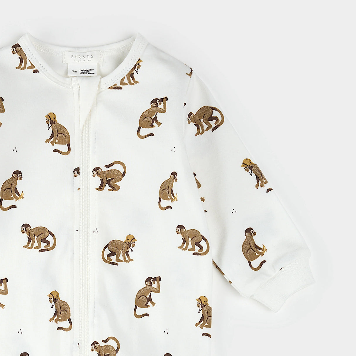 Back view close-up of monkey print baby footed sleeper 0–12 months