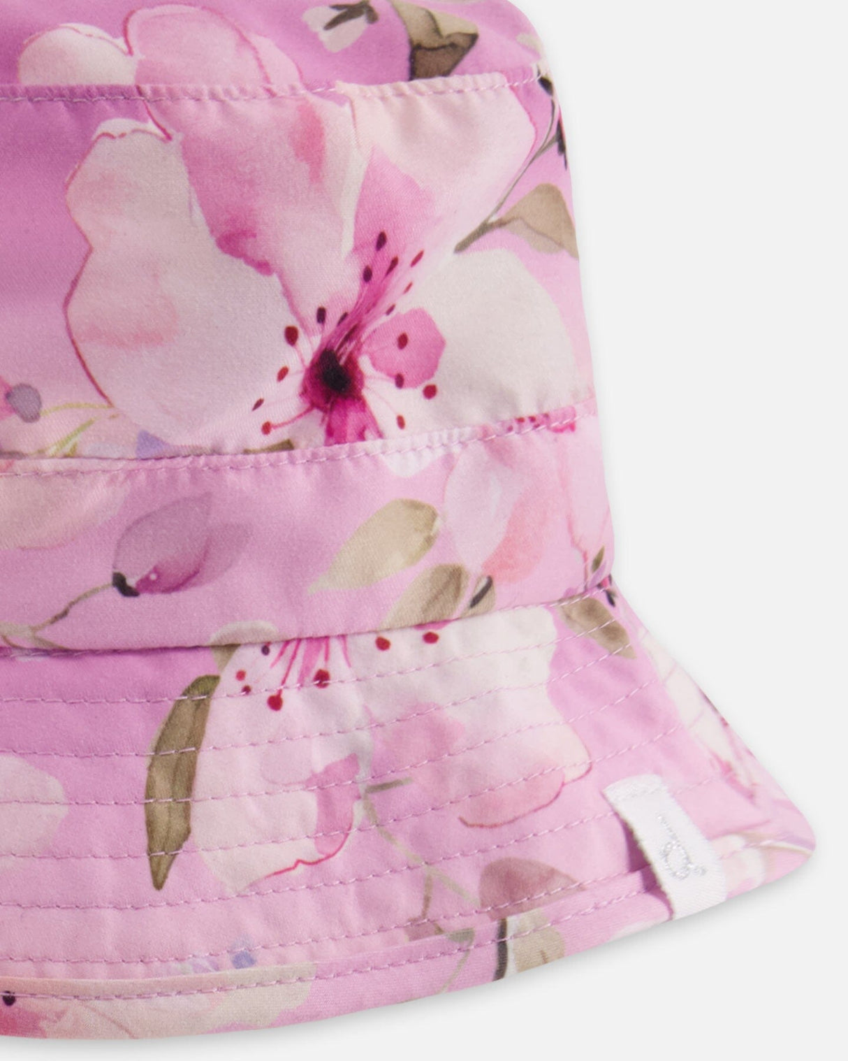 Close-up of floral pattern and ruffled edge on purple girl beach hat