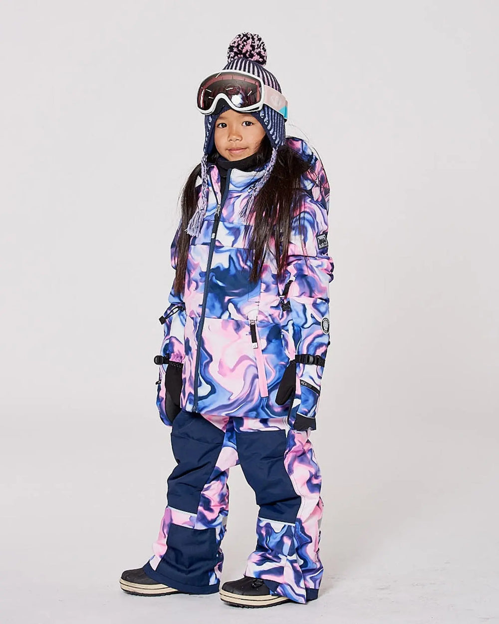 Child wearing Deux par Deux pink/blue marble two-piece Teknik snowsuit – front view