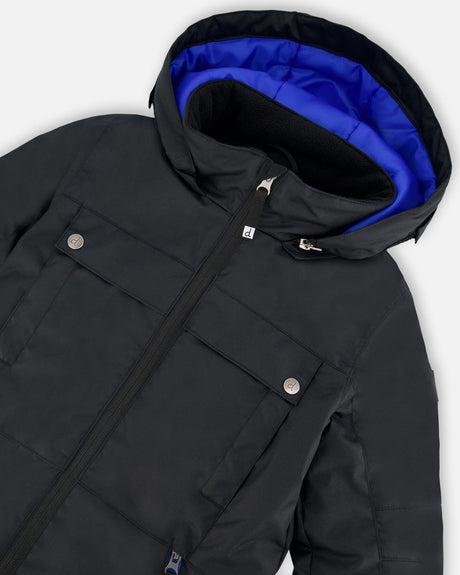 Close-up of detachable helmet-friendly hood and lining on black Teknik snowsuit