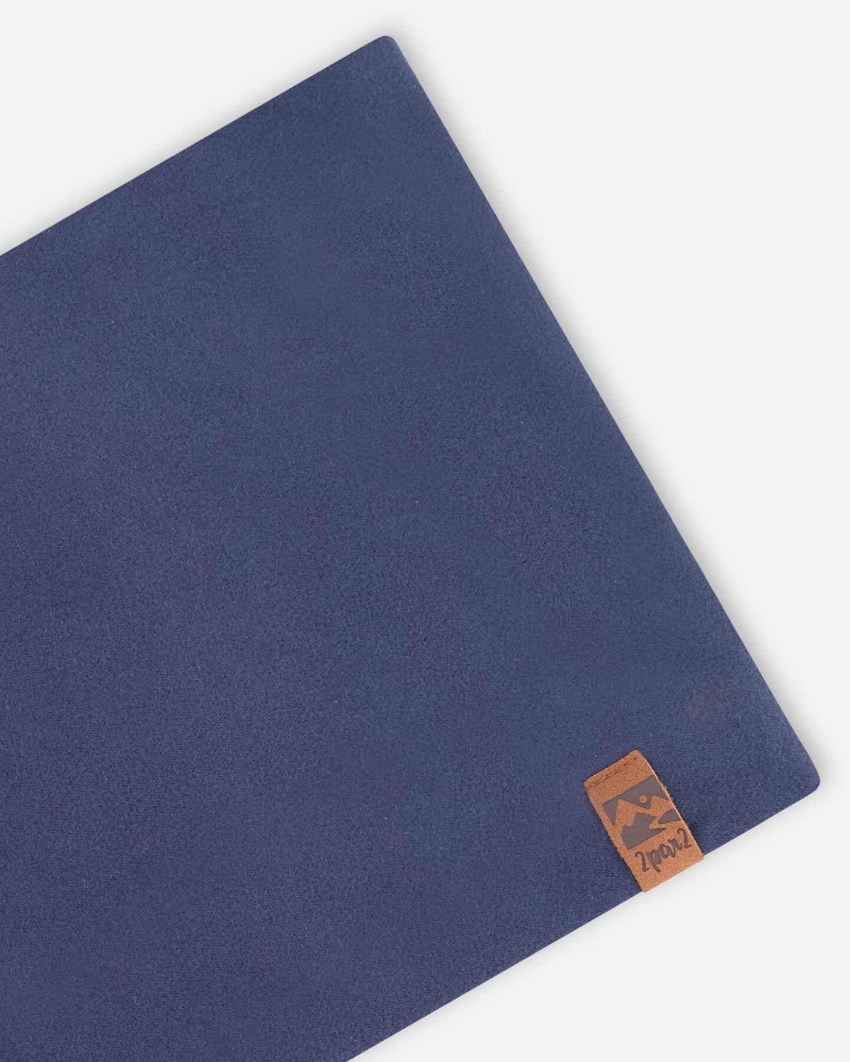 Close-up of the navy jersey and leather-look label on the neck warmer