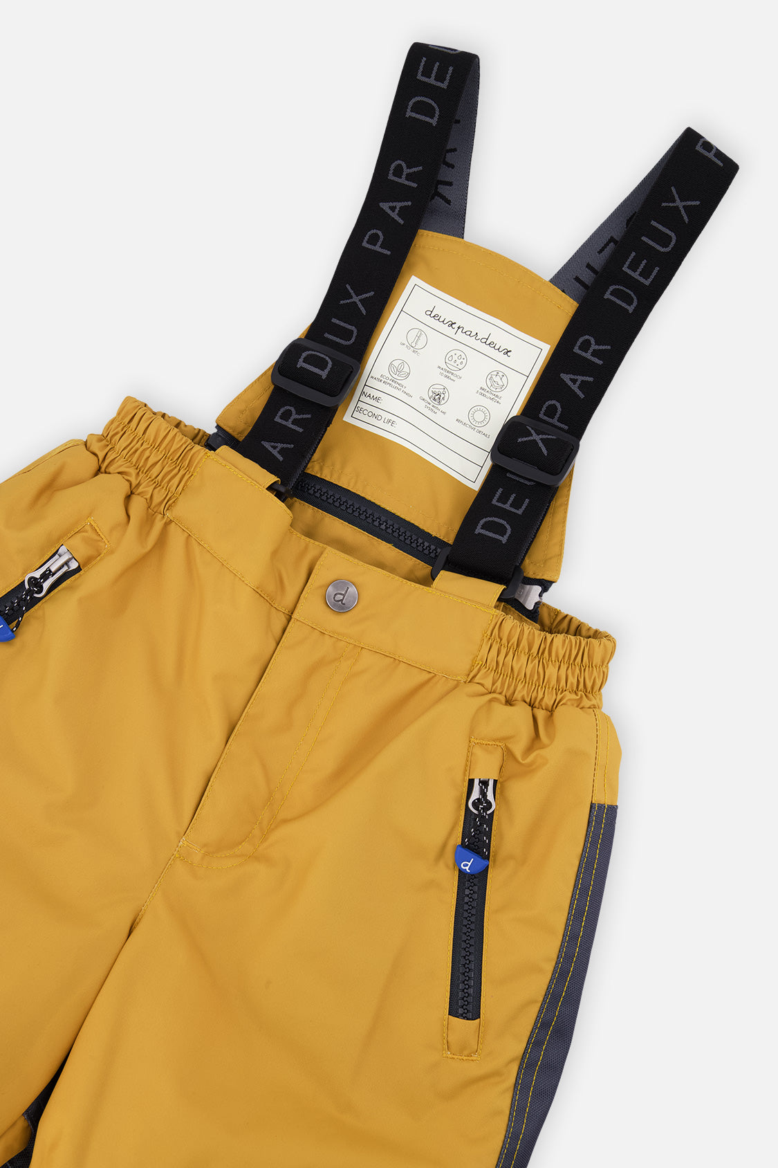 Close-up of the yellow PLAY snow pants waist, zip pocket and Deux par Deux logo suspenders