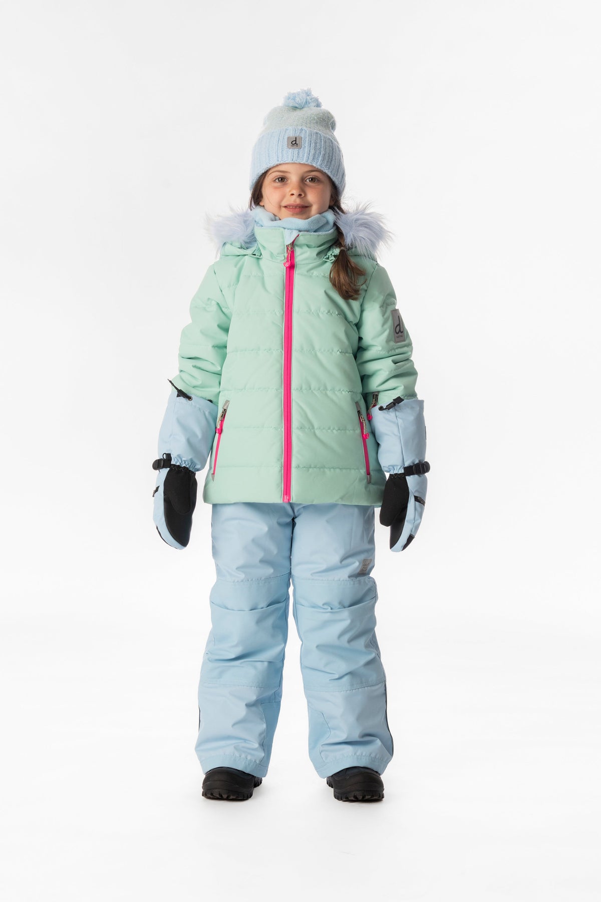 Child wearing the mint green Deux par Deux PLAY snowsuit, lookbook view 1
