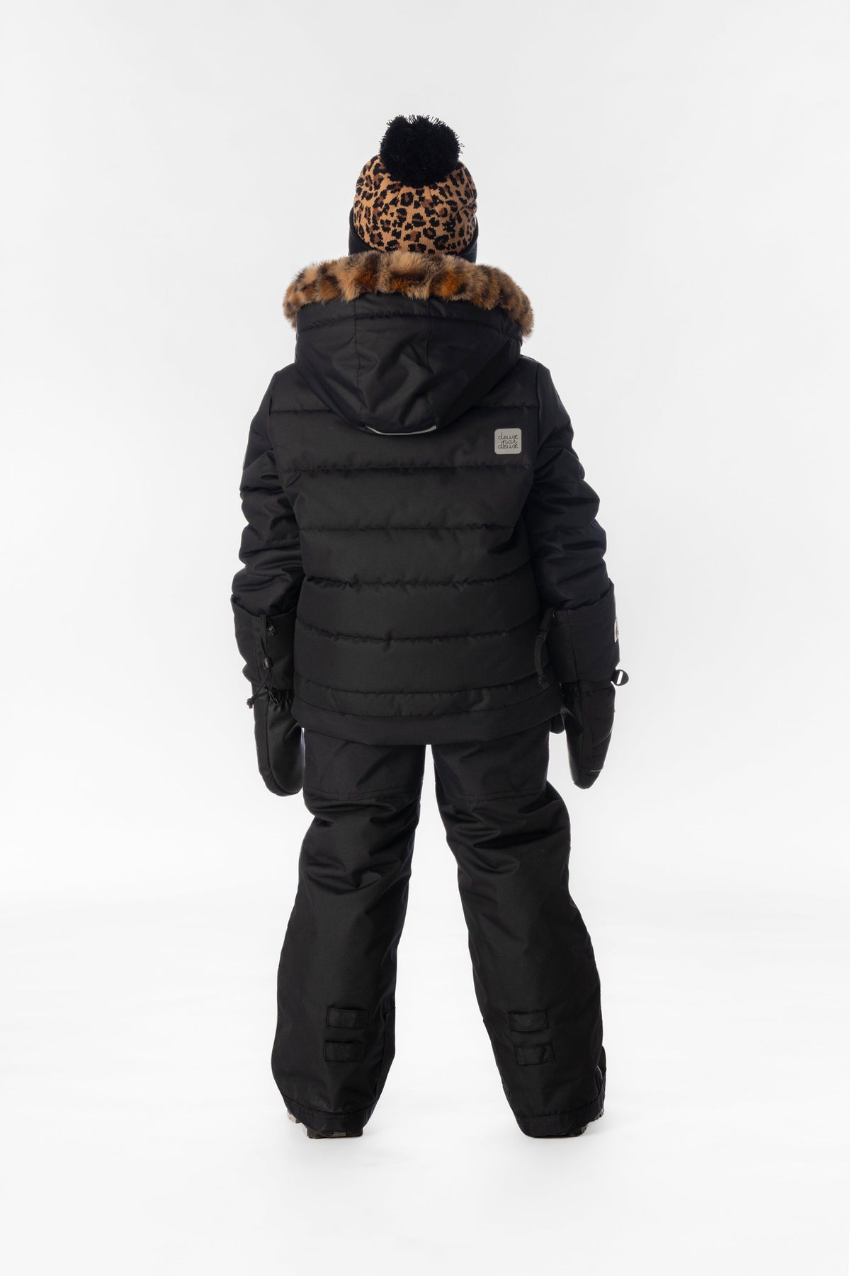 Child wearing the Deux par Deux black PLAY two-piece snowsuit, lookbook photo 3