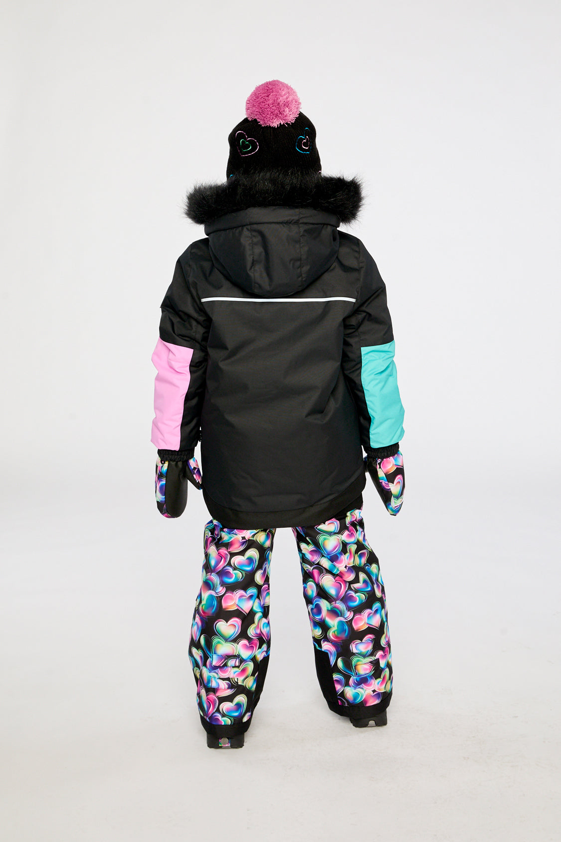 Child wearing the Deux par Deux PLAY heart print snowsuit, third lookbook photo