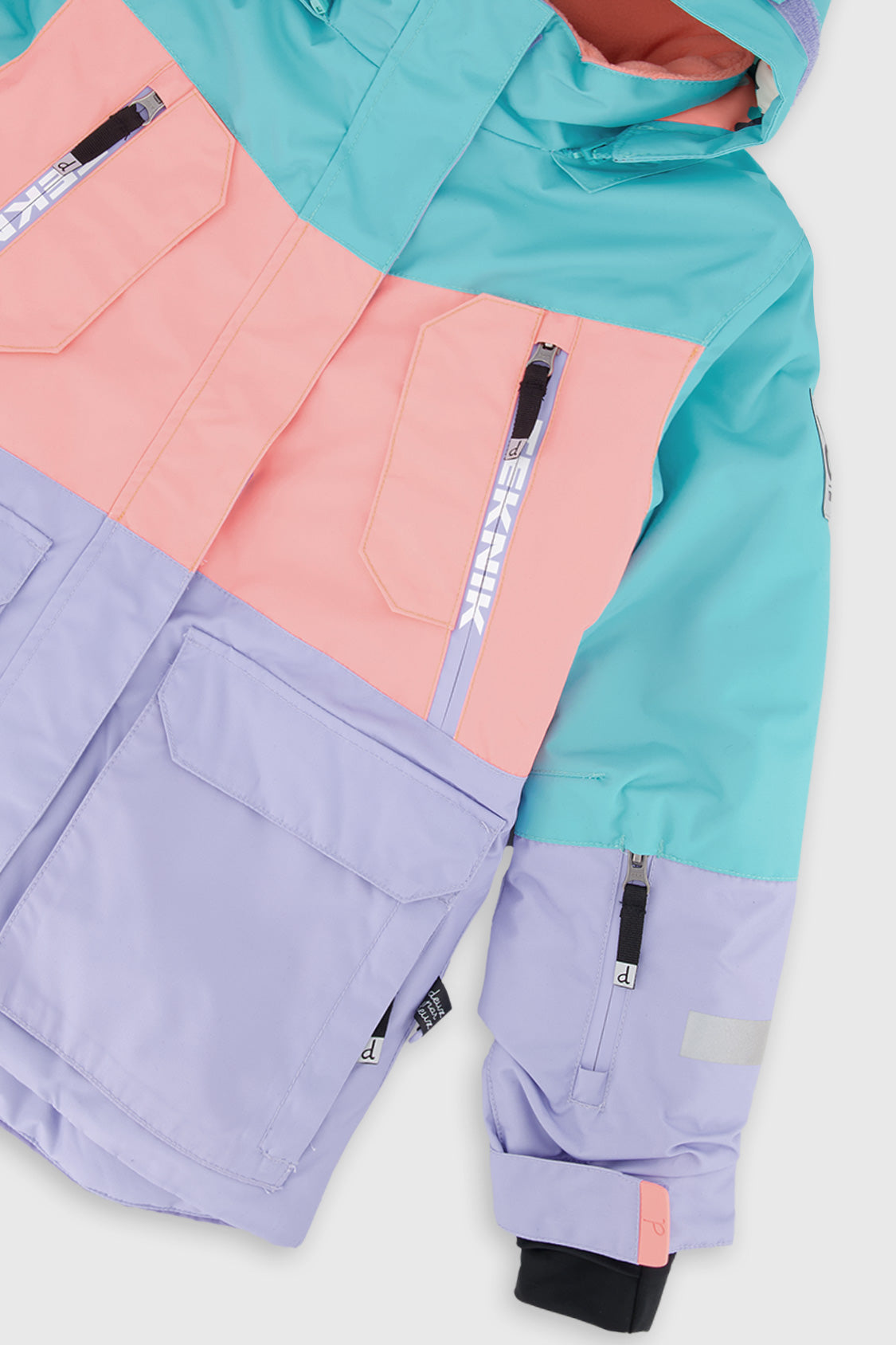 Deux par Deux girls' Teknik two-piece snowsuit in turquoise, orange and mauve color-block – jacket detail close-up