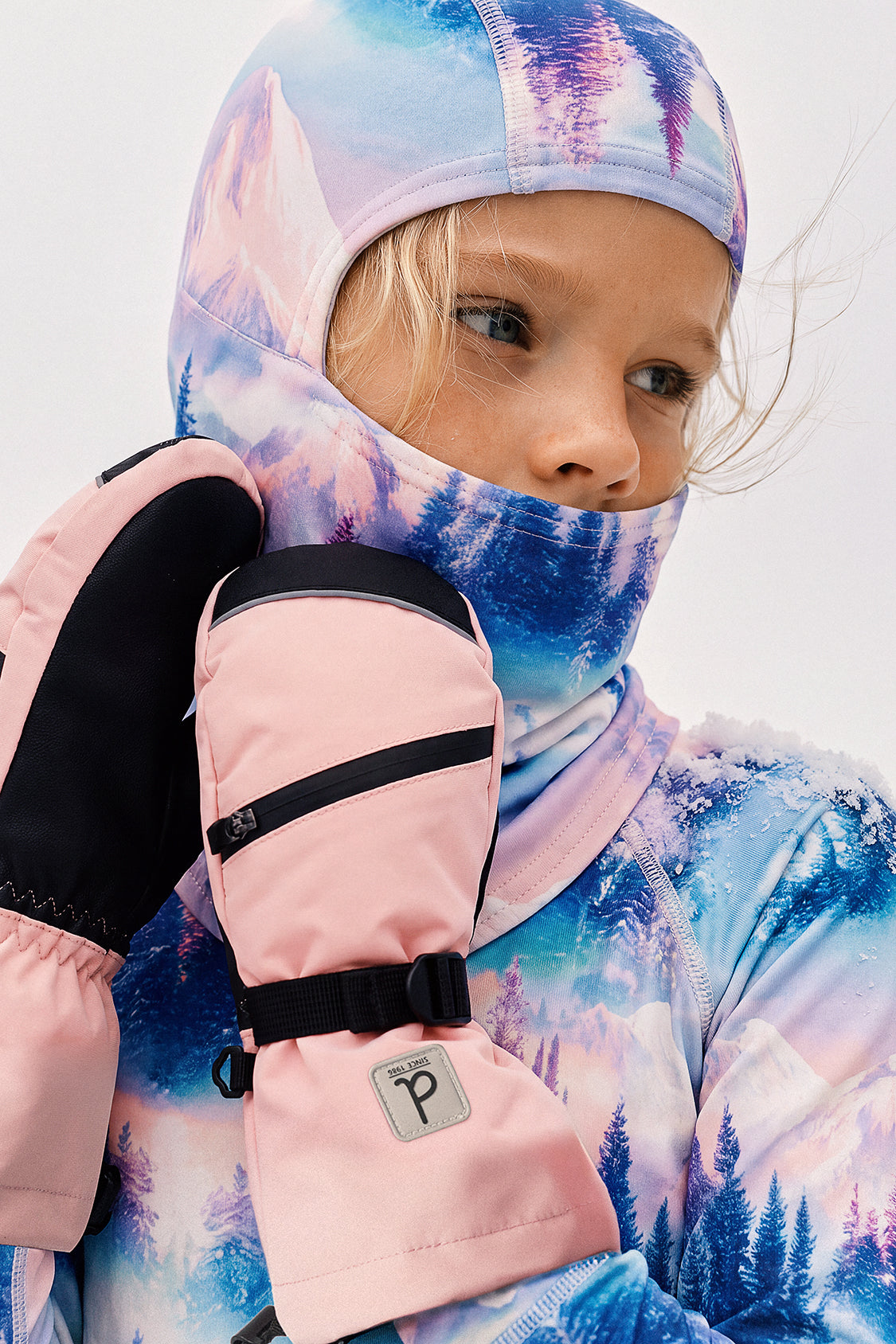 Child wearing the Deux par Deux blue and pink mountain print polar fleece balaclava, view 2