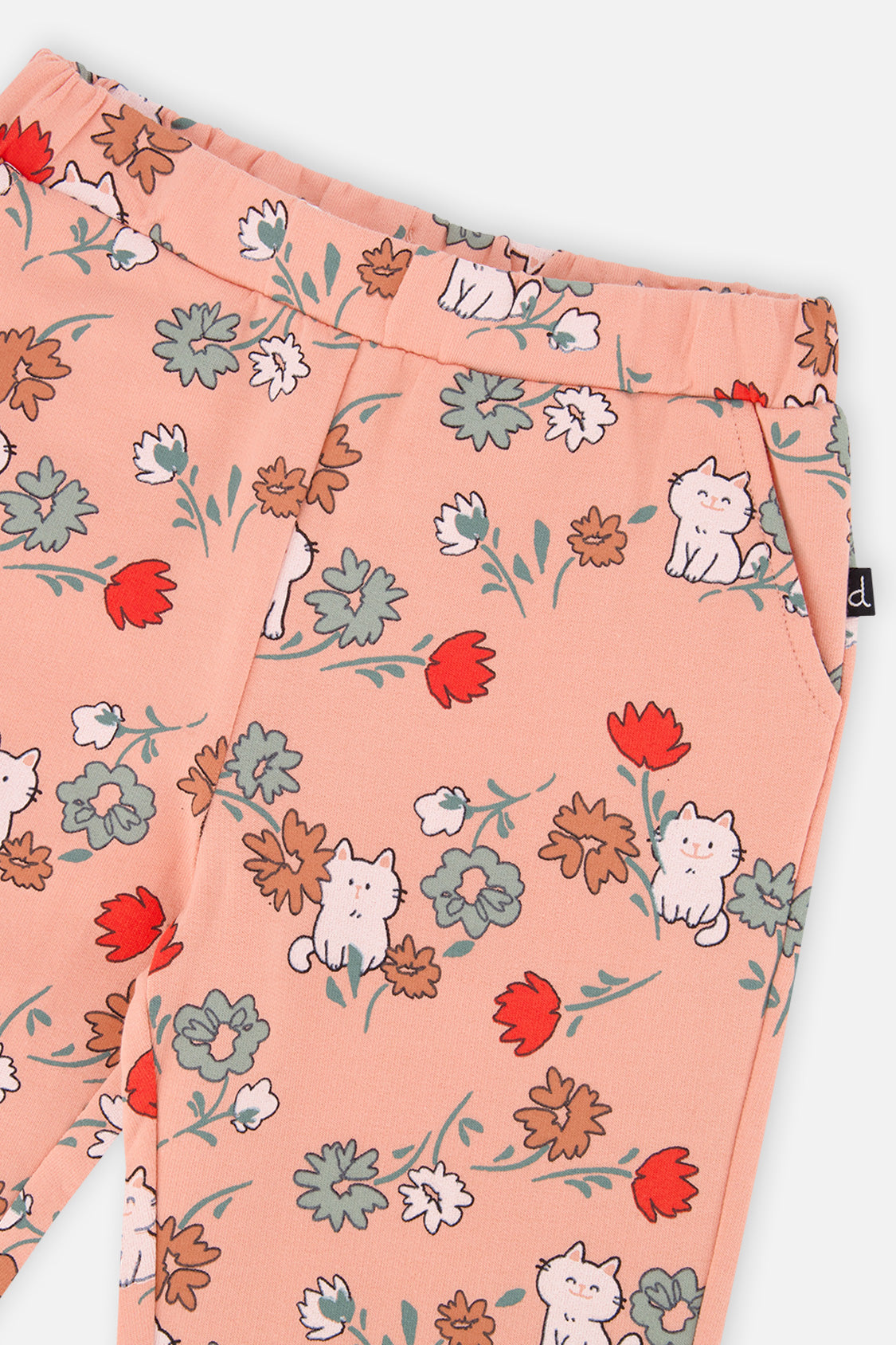 Close-up of the elastic waist and pocket on coral pink French terry sweatpants with a cat print