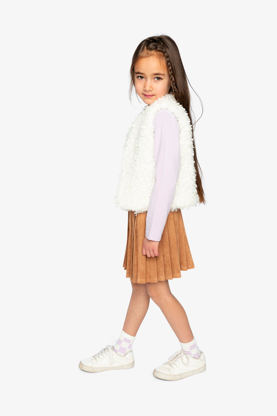 Child wearing the reversible vest with the cream sherpa side out