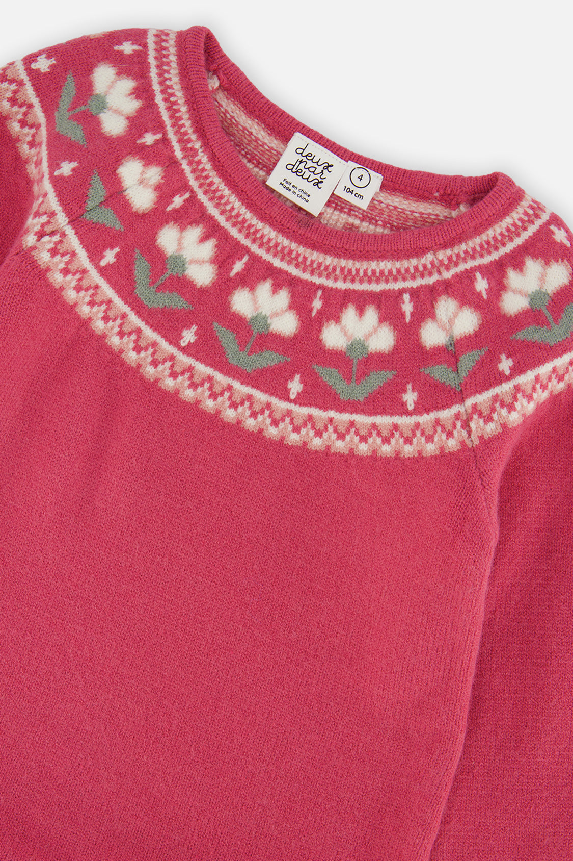 Close-up of the white flower jacquard yoke and ribbed neckline on the raspberry dress