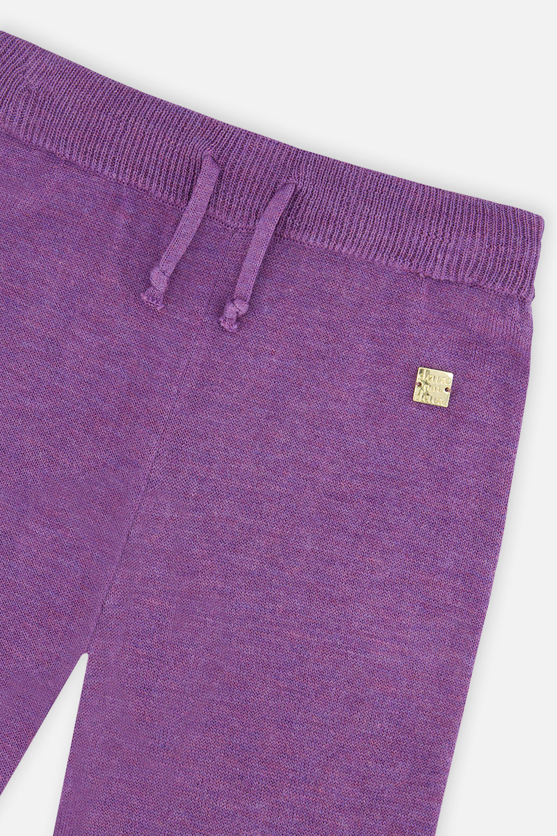 Close-up of the ribbed knit waistband on the violet wide leg pants