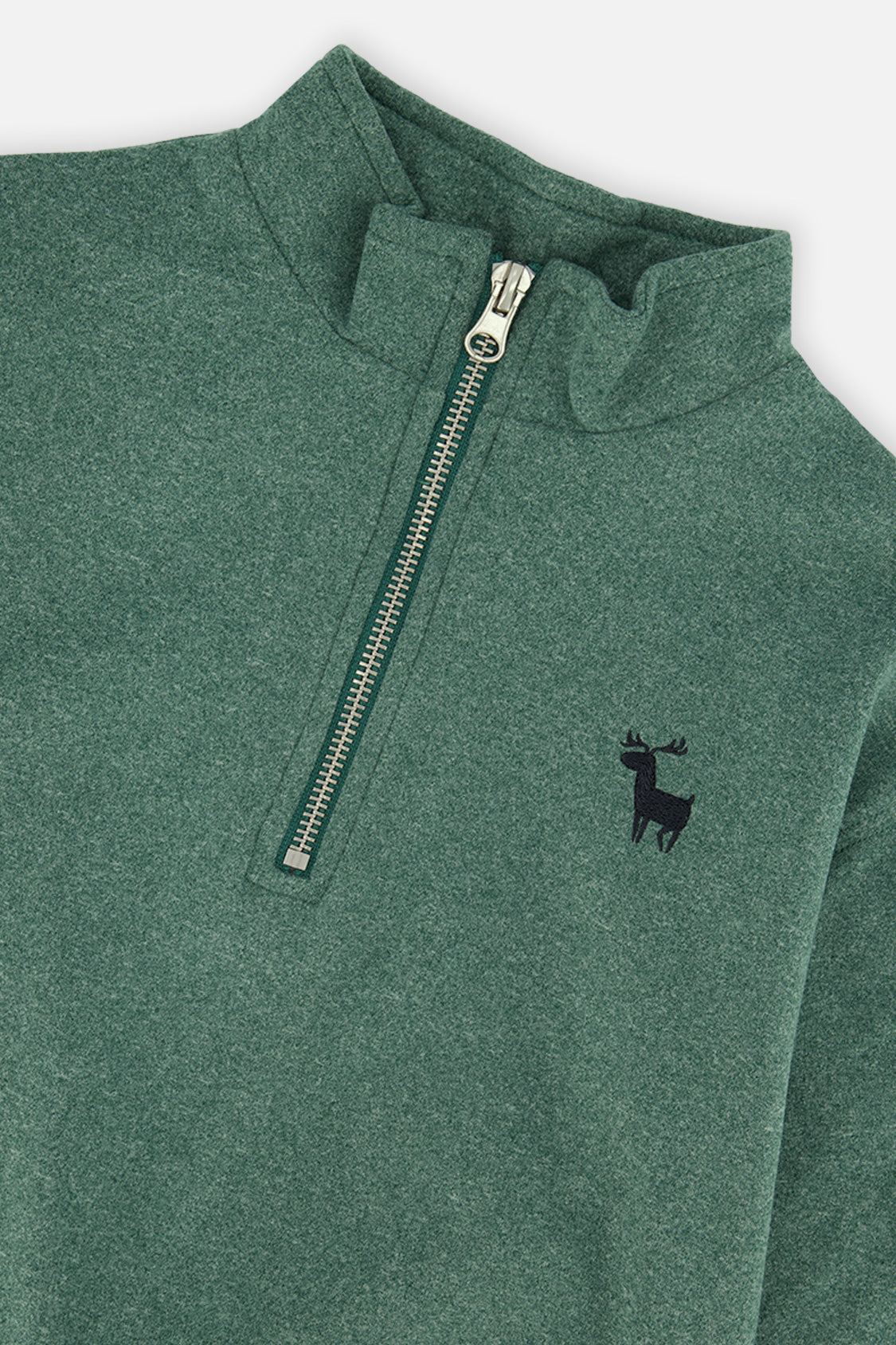 Close-up of the half zip, mock neck and small deer on the dark green sweater
