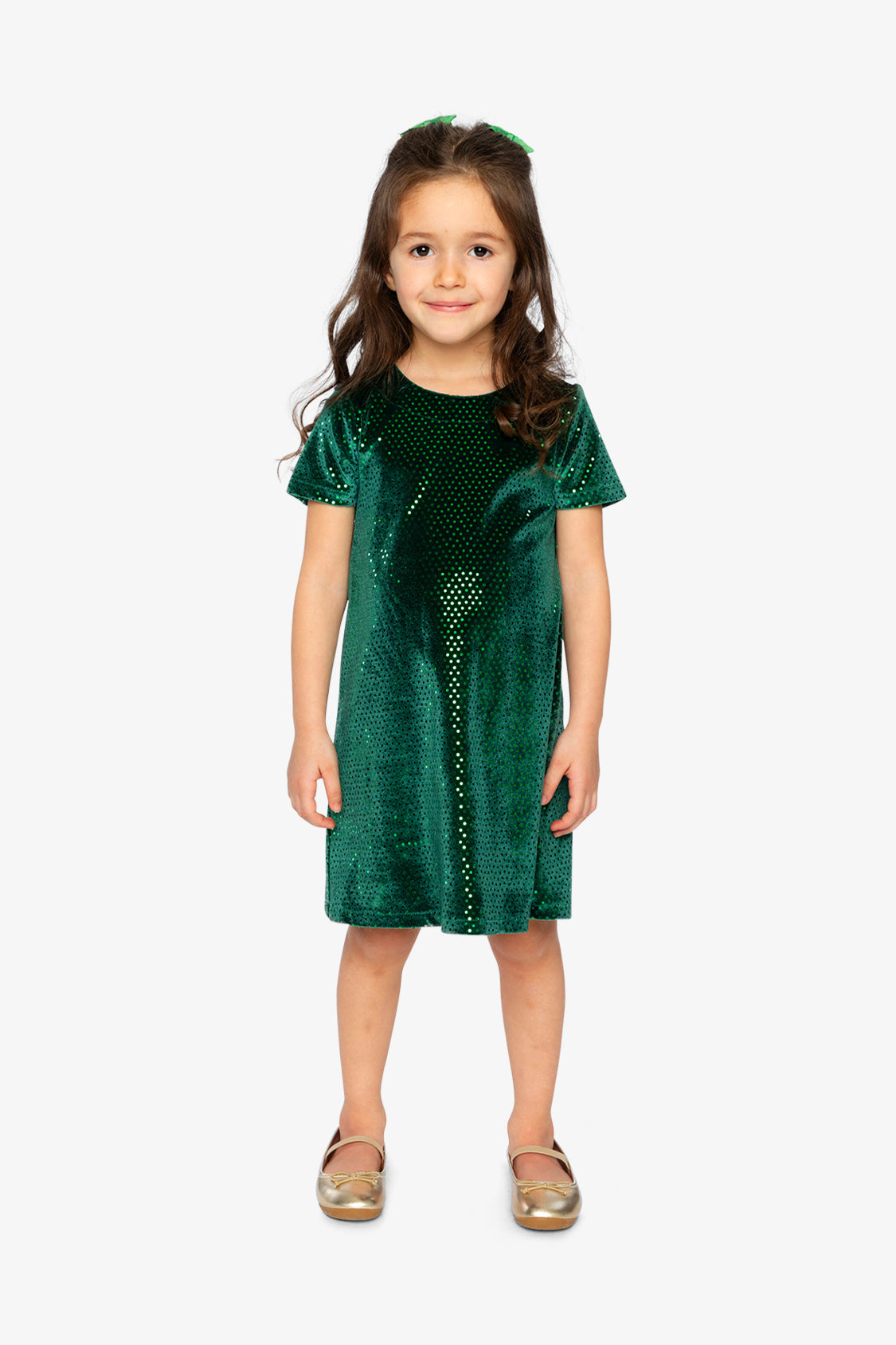 Child wearing the Deux par Deux forest green sparkle velour dress and gold flats