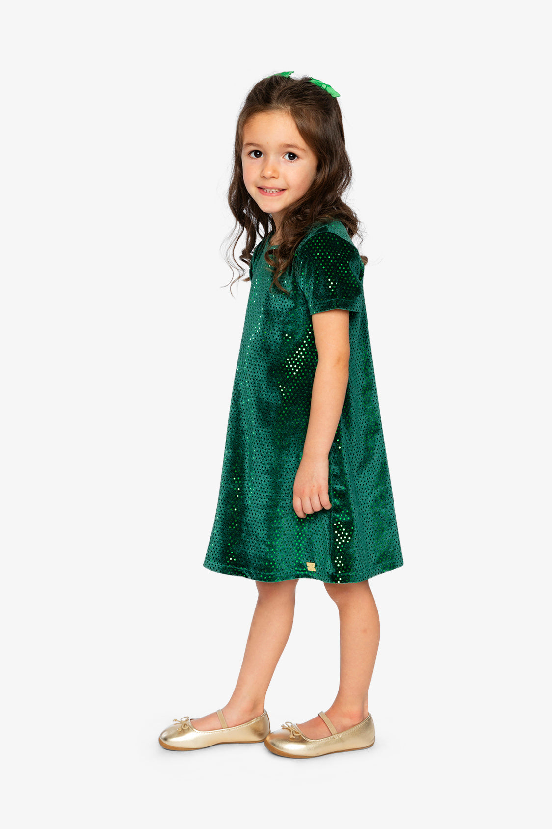 Child wearing the Deux par Deux forest green sparkle velour dress, side view