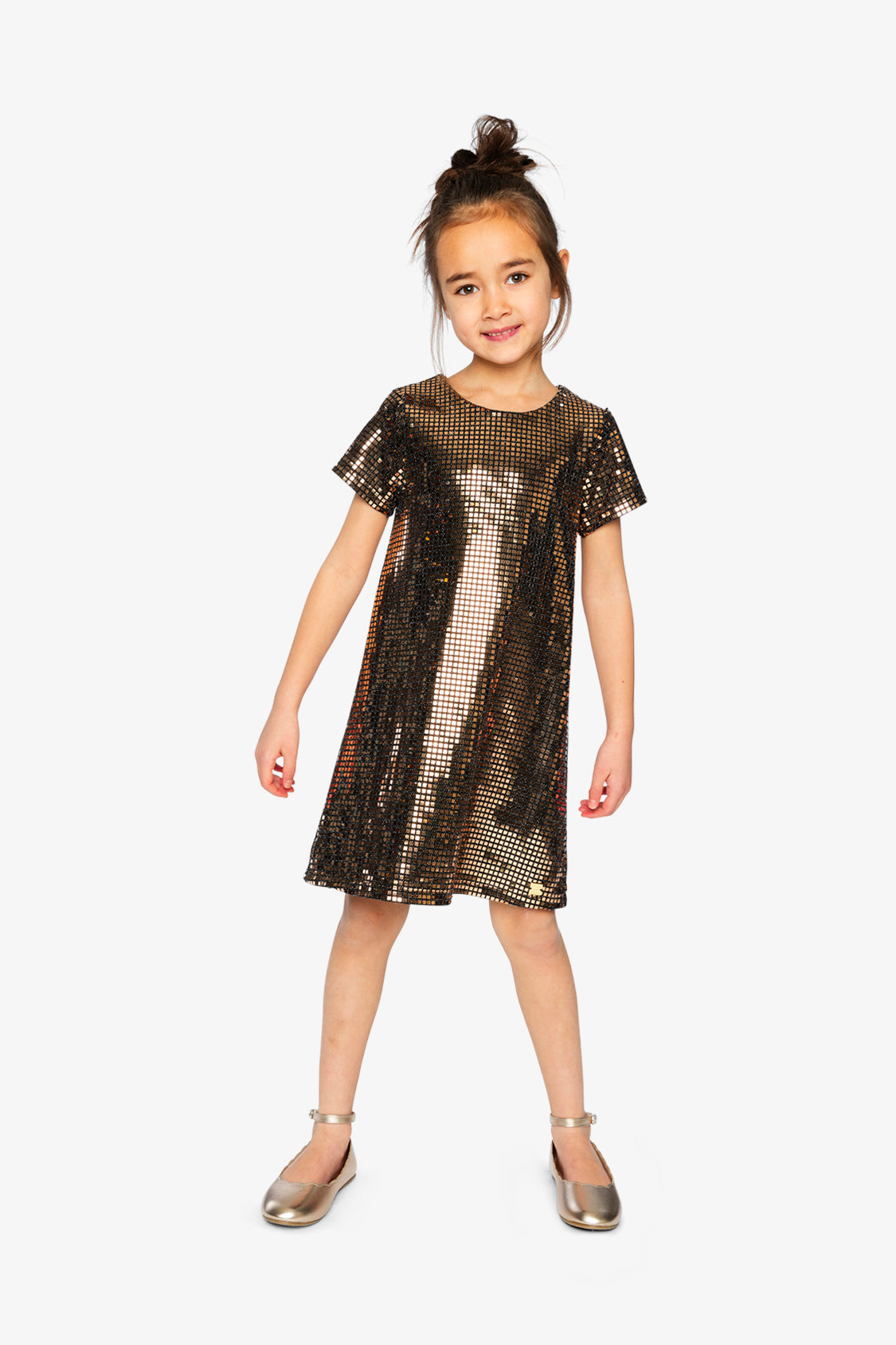 Child wearing the Deux par Deux metallic bronze gold A-line dress with gold ballet flats