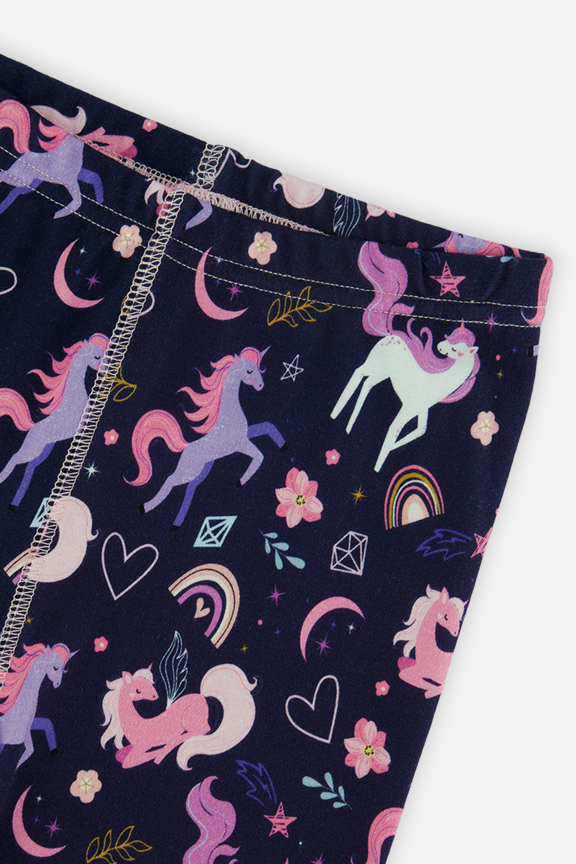 Close-up of the elastic waistband and unicorn rainbow print on the navy pants