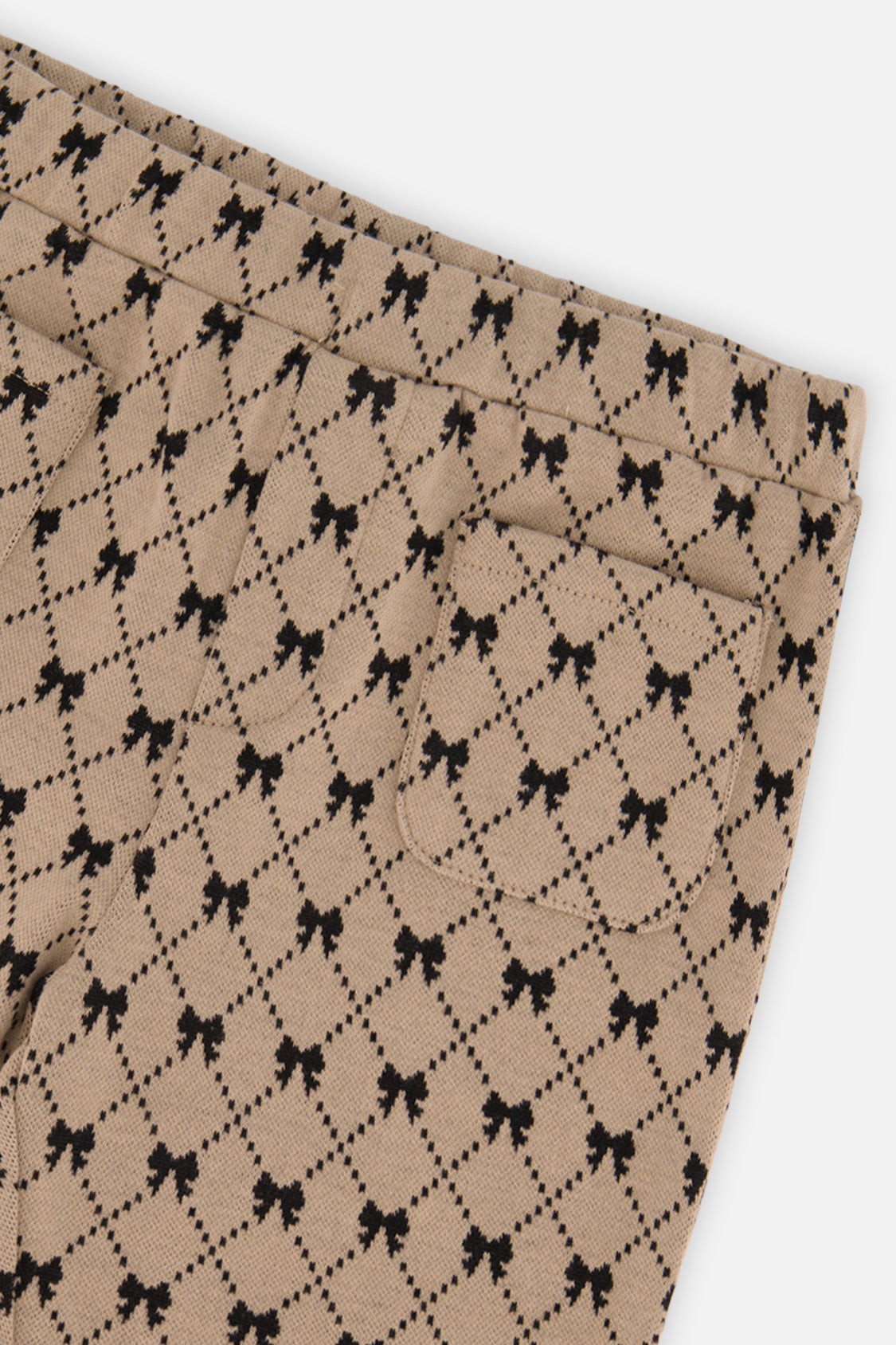 Close-up of the bow print and back pocket on the Deux par Deux beige treggings