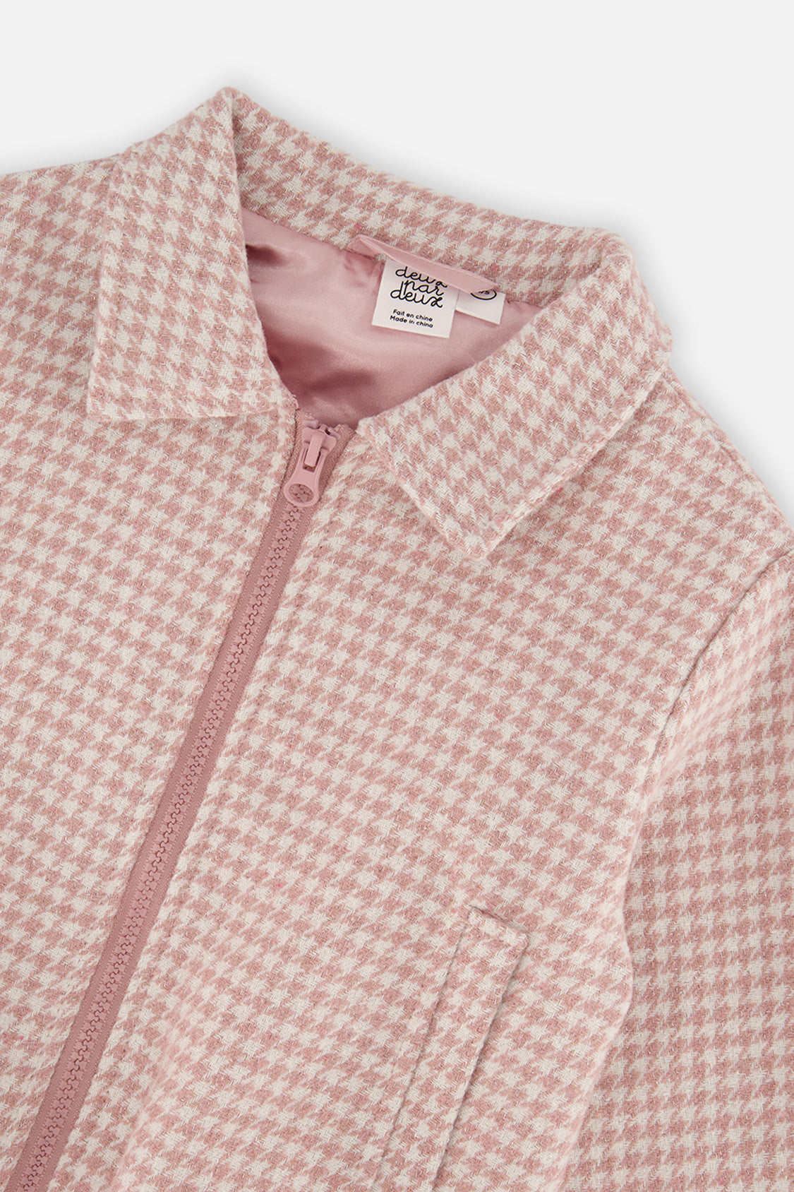 Close-up of the collar, pink zipper and pink lining on the houndstooth bomber