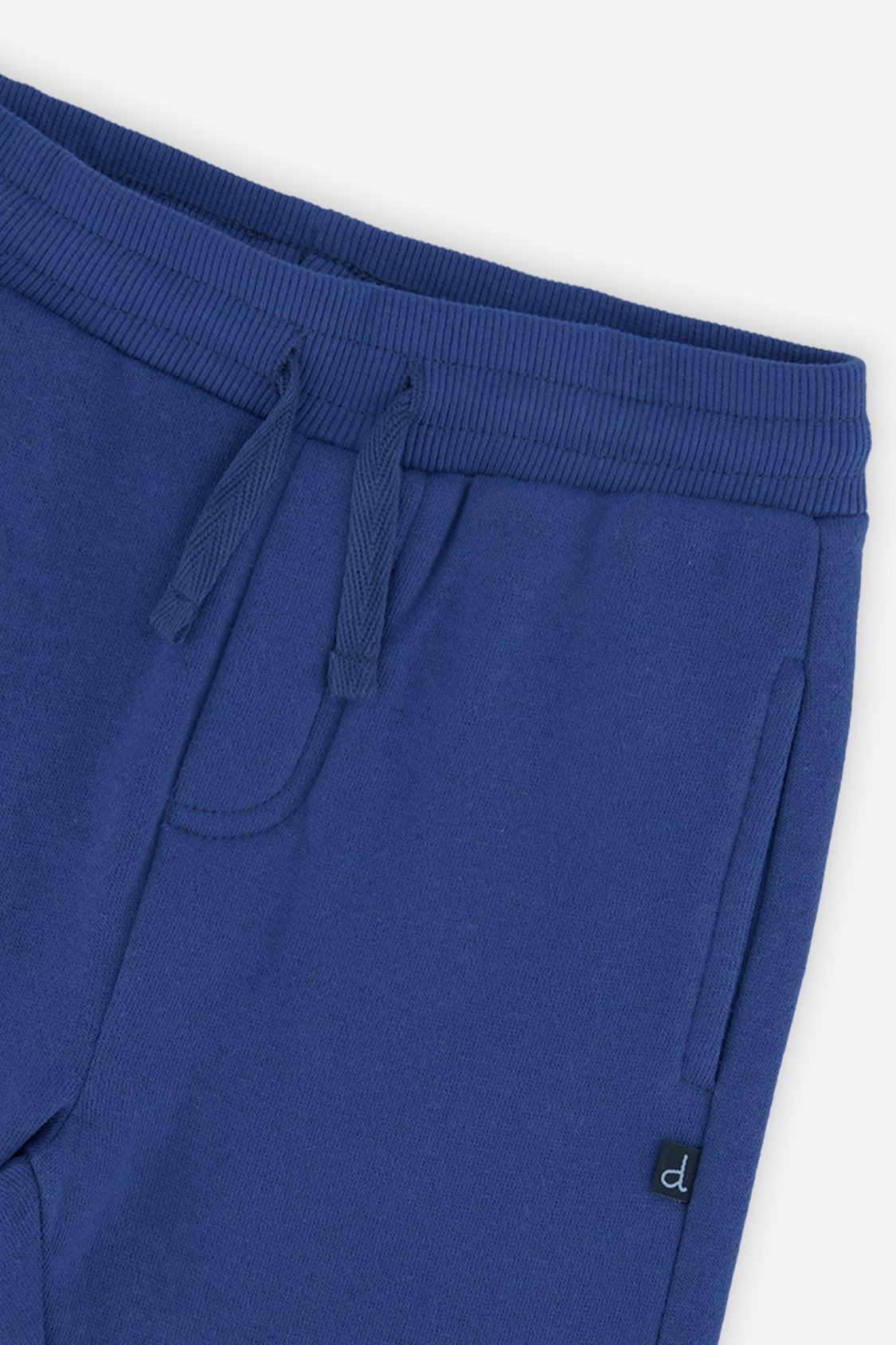 Close-up of the ribbed waistband, drawstring and side pocket on the blue sweatpants