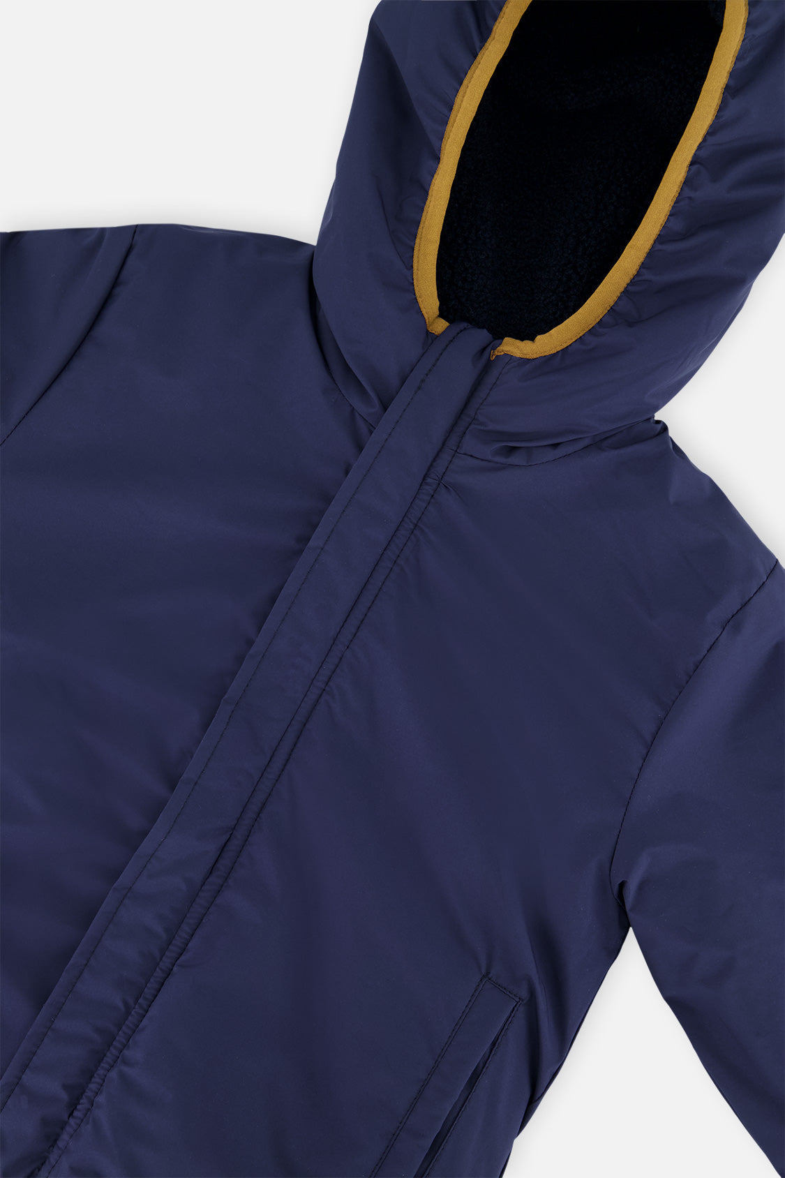 Close-up of the dark blue coated side and the hood opening of the reversible jacket