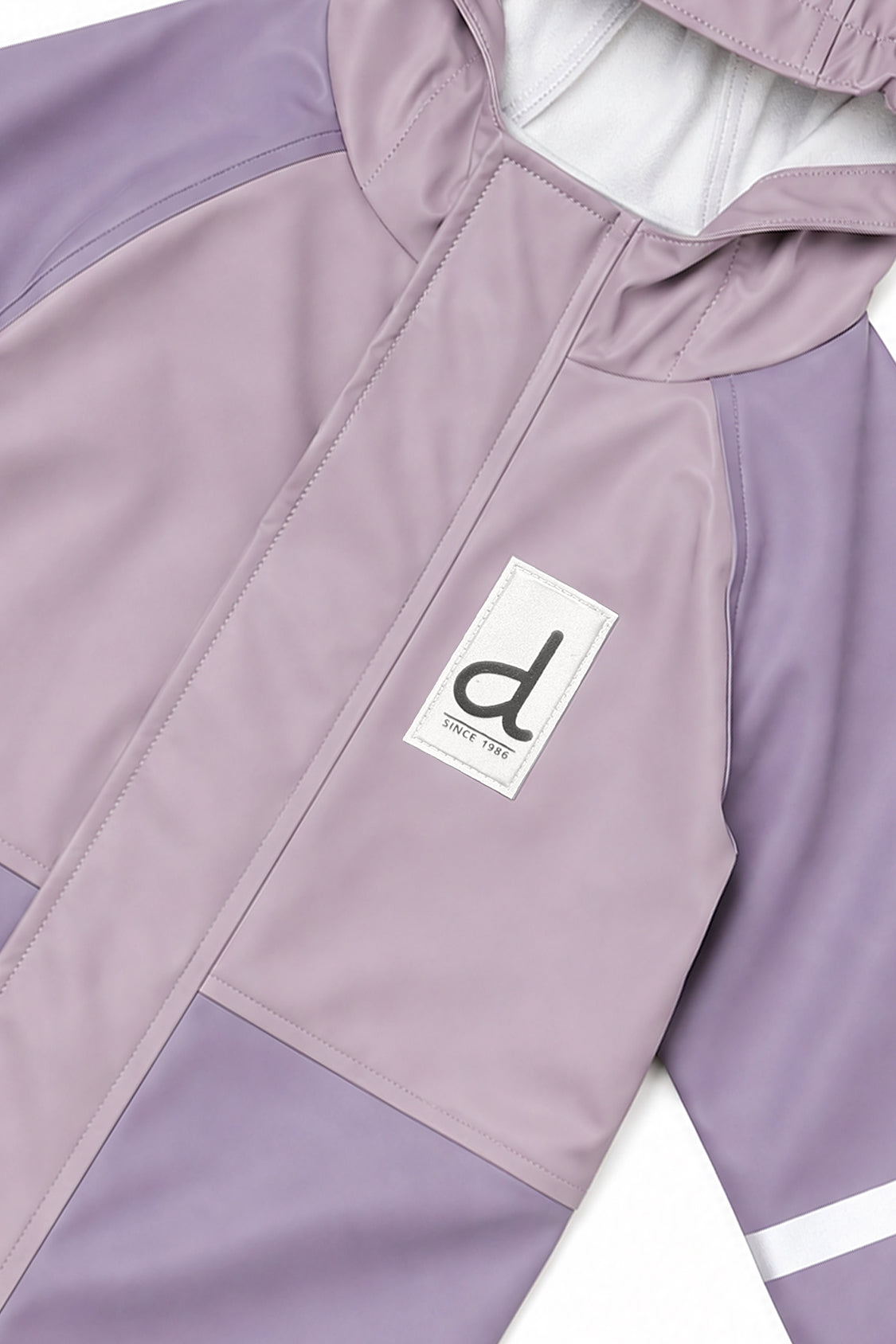Close-up of the two-tone mauve front, zipper placket and d logo patch