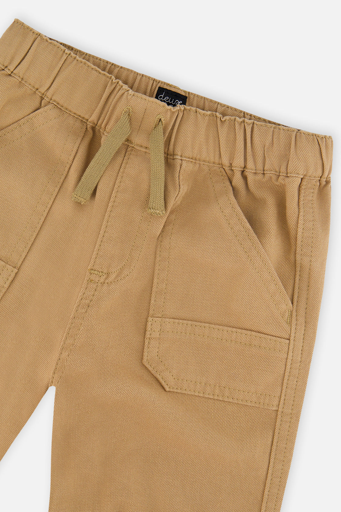 Close-up of the elastic waist, drawcord and patch pocket on beige stretch canvas jogger pants