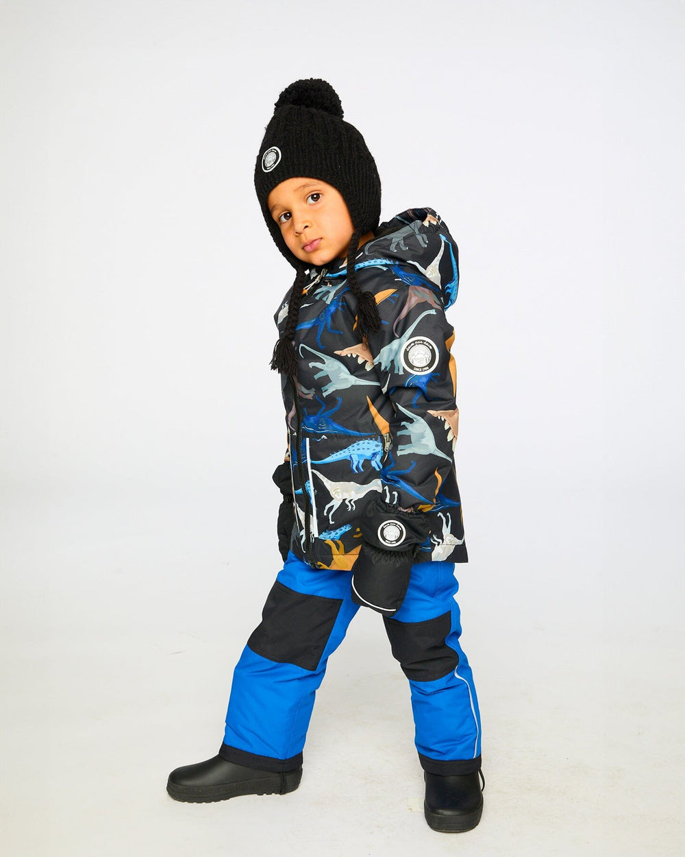 Lifestyle photo of child wearing Deux par Deux blue chill snowsuit outdoors