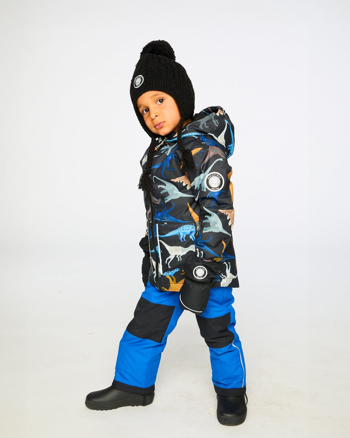 Lifestyle photo of child wearing Deux par Deux blue chill snowsuit outdoors