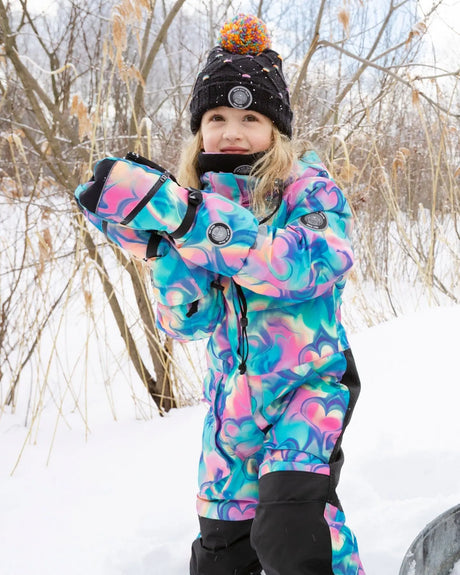Action shot in colorful one-piece snowsuit, detachable hood and grow sleeves.