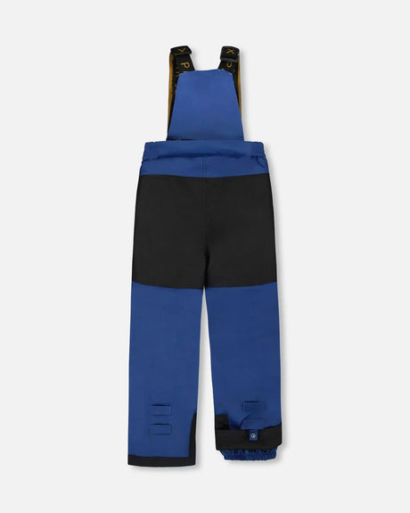 Close-up Cordura® reinforced knee on navy bib pants from Deux Par Deux dinosaur snowsuit