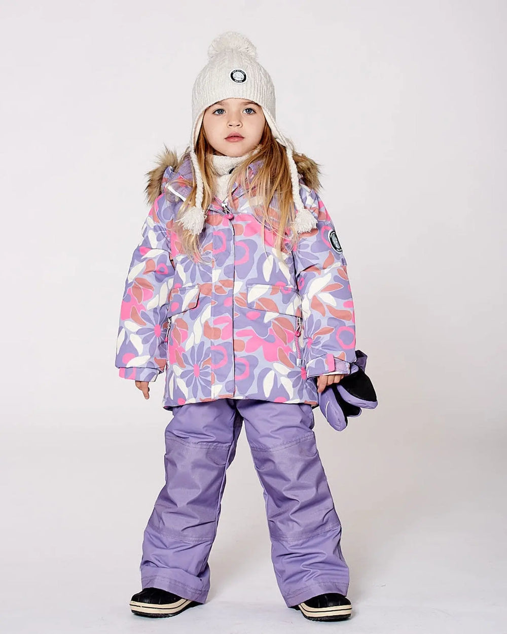 Model wearing Purple/Gray jacket and snow pants, detachable hood.
