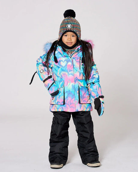Model wearing multicolor jacket and snow pants, detachable hood, breathable shell.