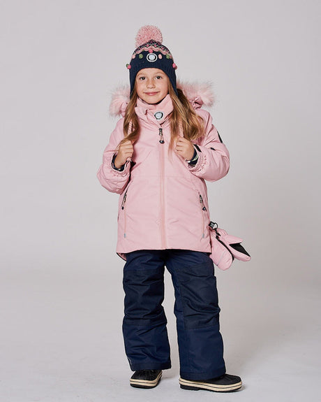 Model in two-piece ski suit pink hood up, navy bib pants — almost gone