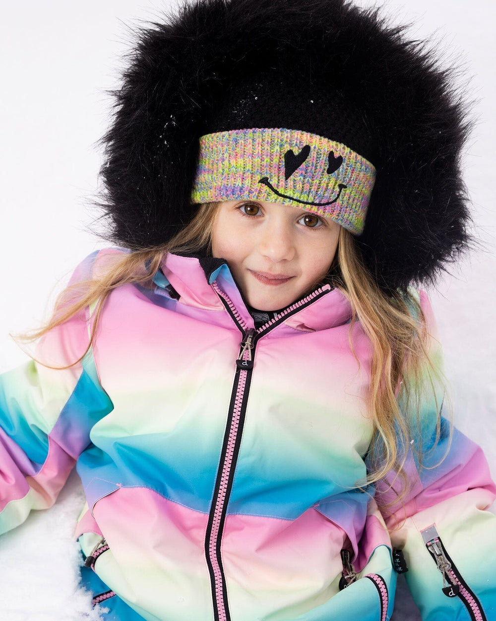 Back view of rainbow jacket with faux-fur hood, two-piece ski suit.