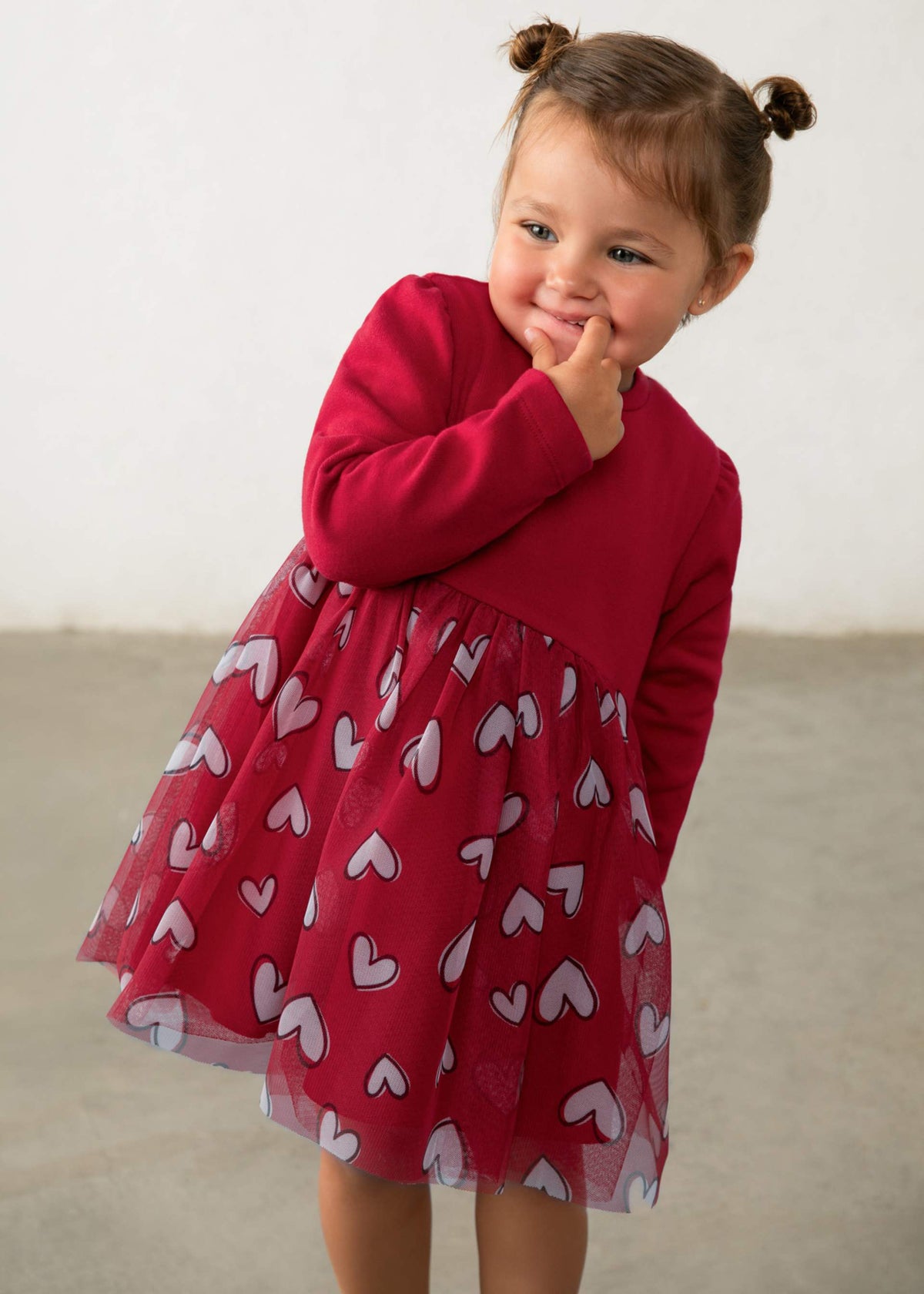 Child wearing the Mayoral red long-sleeve dress with heart-print tulle skirt