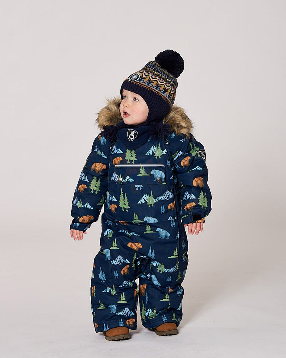 Lifestyle photo of toddler wearing the Deux par Deux navy animal snowsuit outdoors