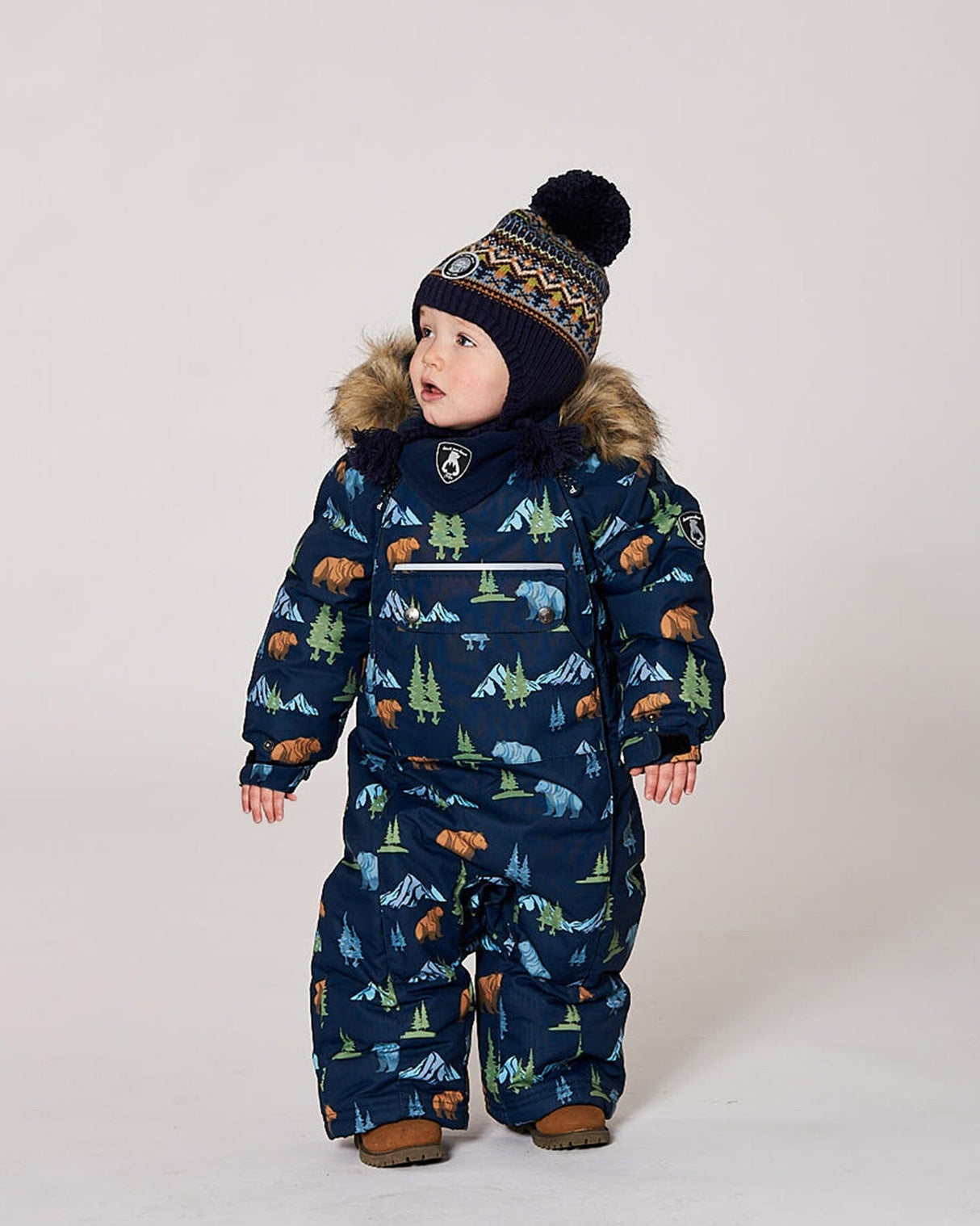 Lifestyle photo of toddler wearing the Deux par Deux navy animal snowsuit outdoors