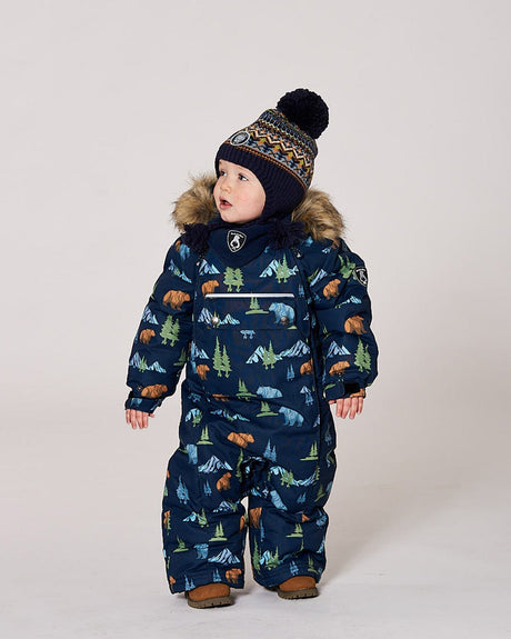 Lifestyle photo of toddler wearing the Deux par Deux navy animal snowsuit outdoors