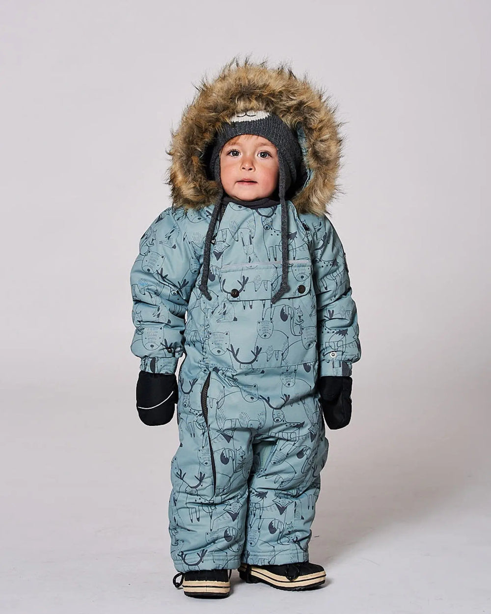 Infant wearing sage green animal print snowsuit with faux fur hood