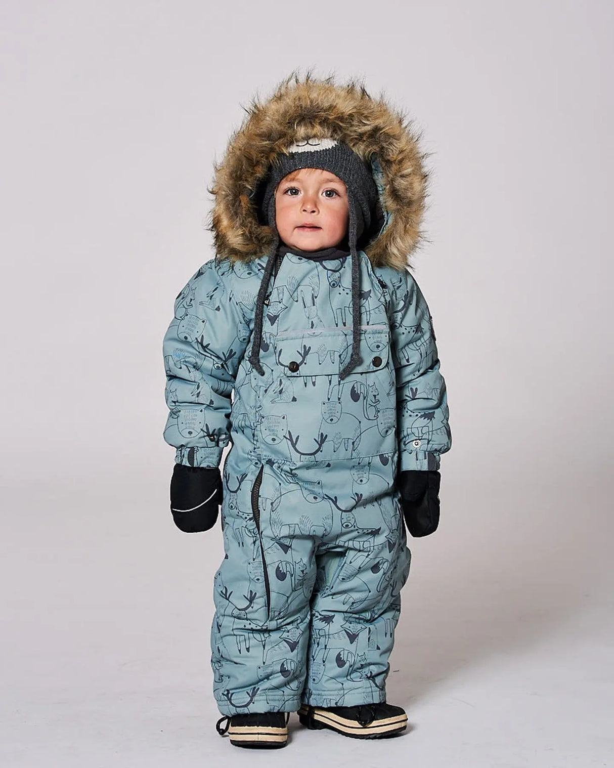Infant wearing sage green animal print snowsuit with faux fur hood