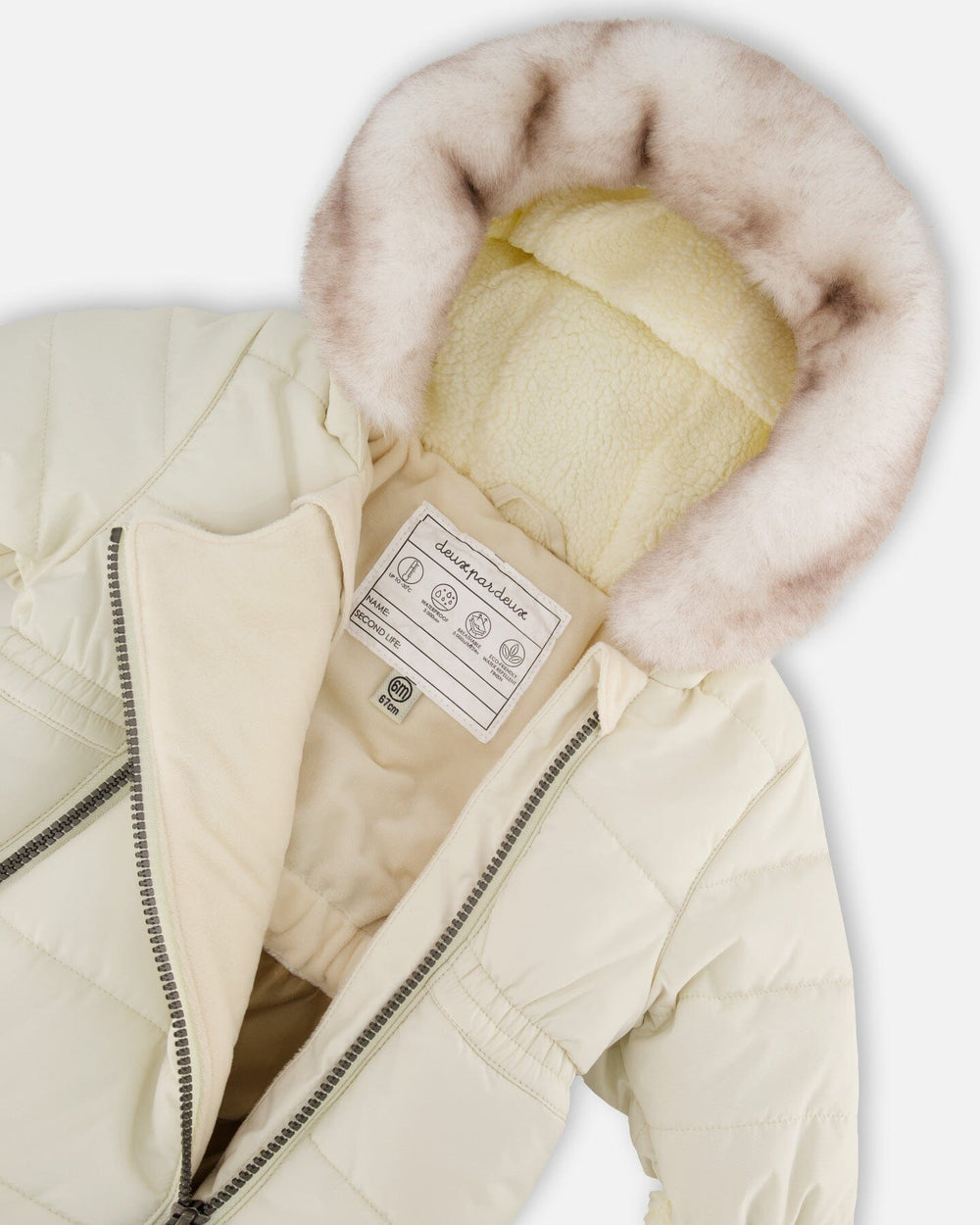 Close-up of the sherpa-lined hood, chin guard, and velour body lining of the White Asparagus snowsuit.