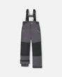Flat lay of Deux Par Deux kids snow pants dark gray with suspenders