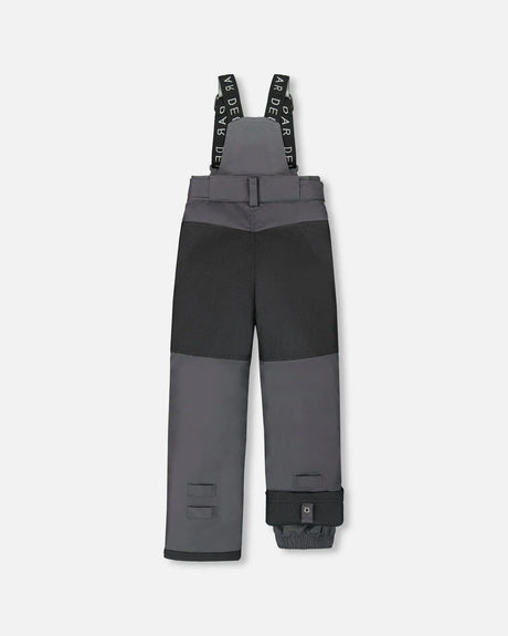 Rear view of dark gray kids snow pants with suspenders