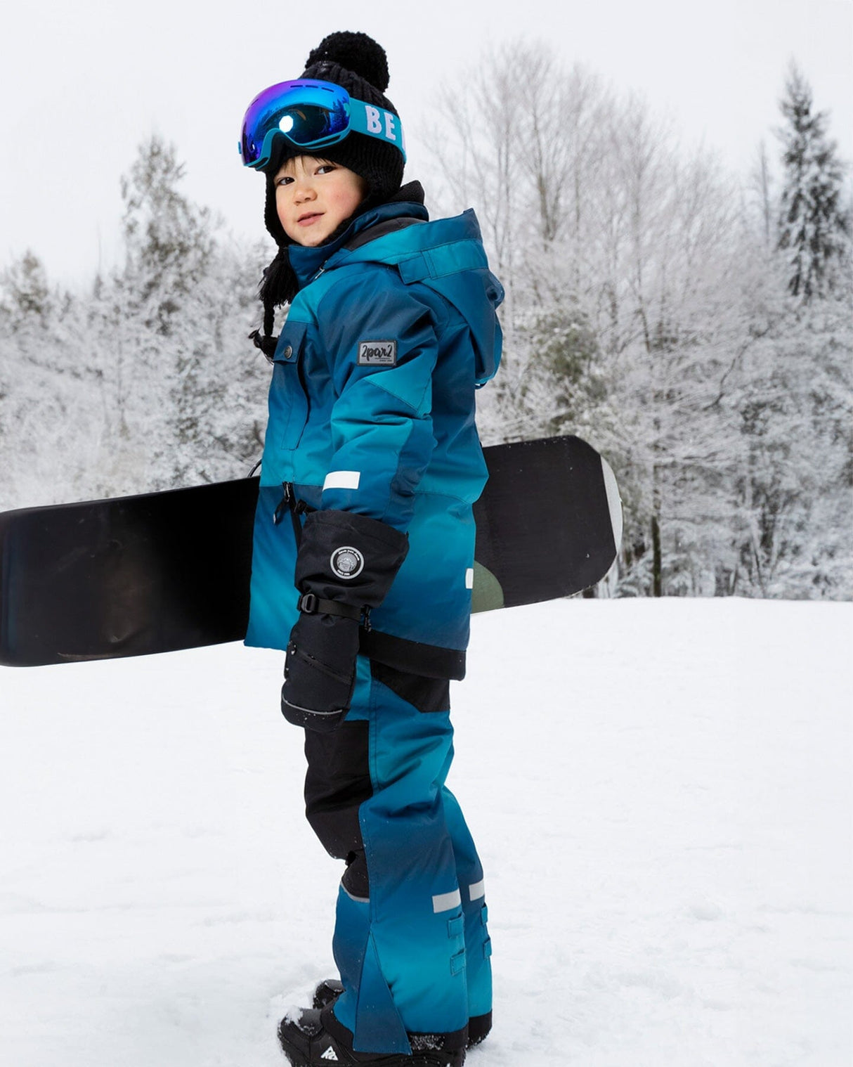Lifestyle photo – toddler snow play in Deux par Deux teal gradient snowsuit
