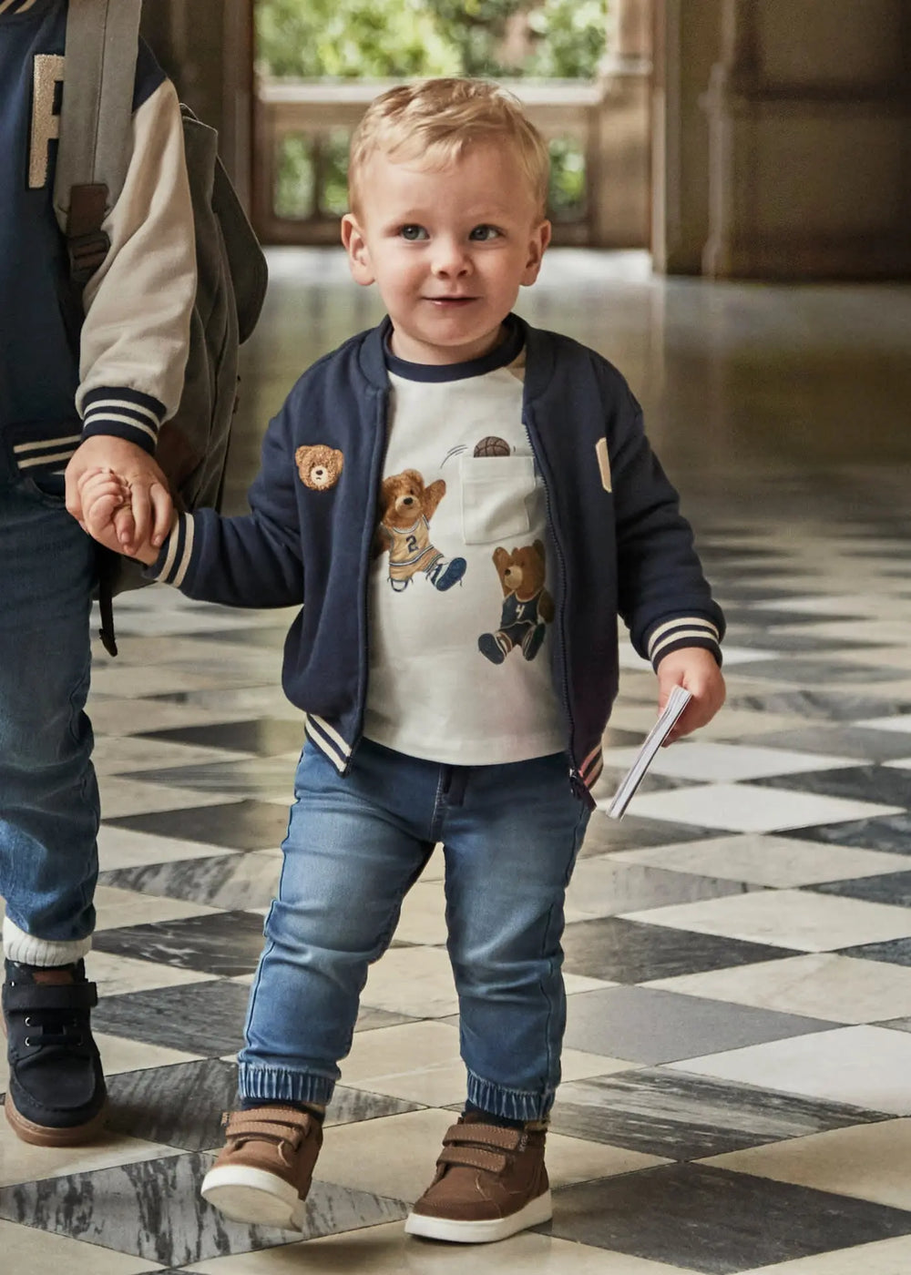 Toddler wearing Mayoral baby denim jogger pants, tapered legs for easy movement