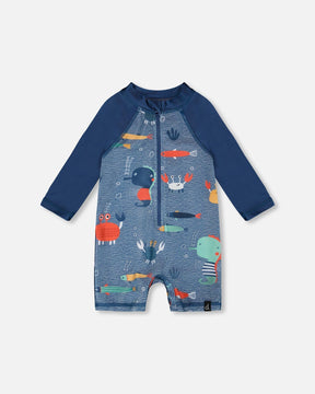 Front flat lay of Deux par Deux baby boy long sleeve one-piece swimsuit in blue marine animals print