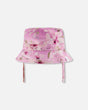 Front view of Deux par Deux purple flower print kids sun hat with chin straps