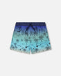 Front flat lay of Deux par Deux boy blue beach boys swim trunks with palm-tree print