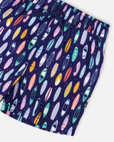 Close-up of waistband, drawstring, and colorful surfboard pattern on swim shorts