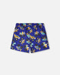 Front flat lay of Deux par Deux boy blue truck print boys swim trunks
